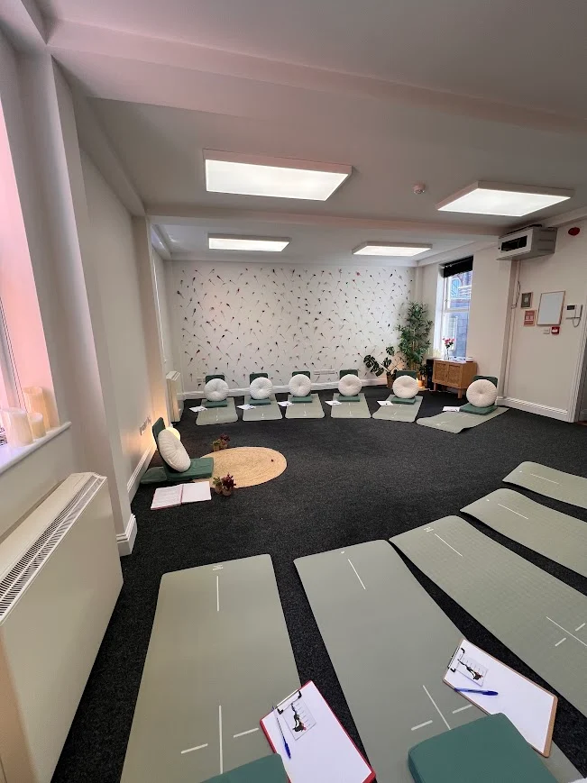 Anú Room laid out with yoga mats and floor seating
