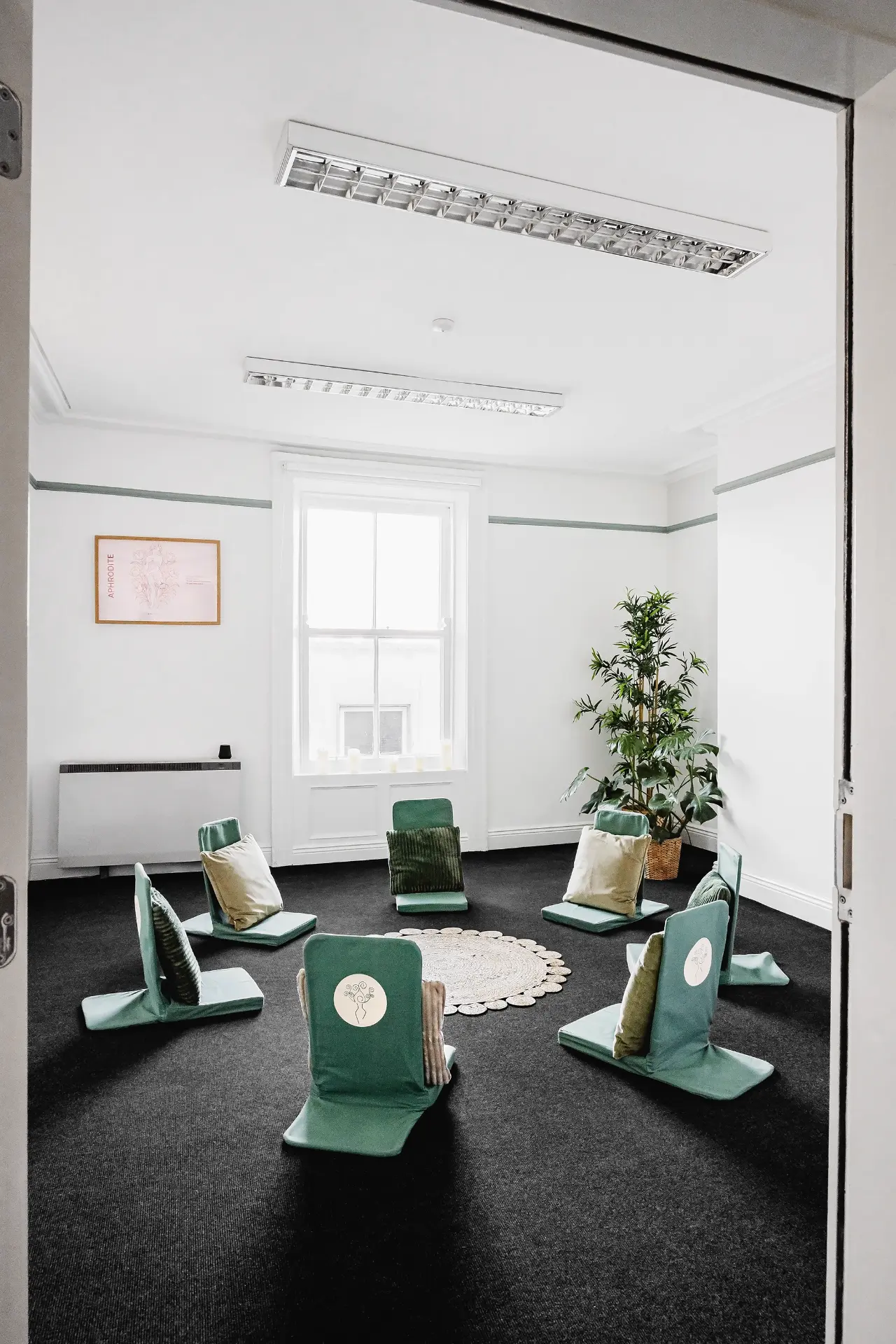 Floor chairs arranged in a circle for small group work in the Aphrodite Room